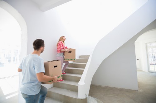 Packed moving boxes and furniture ready for transport in a Maida Vale flat