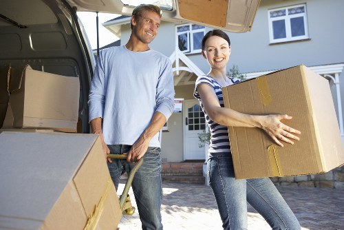 Local removals crew carrying furniture through a Maida Vale apartment building